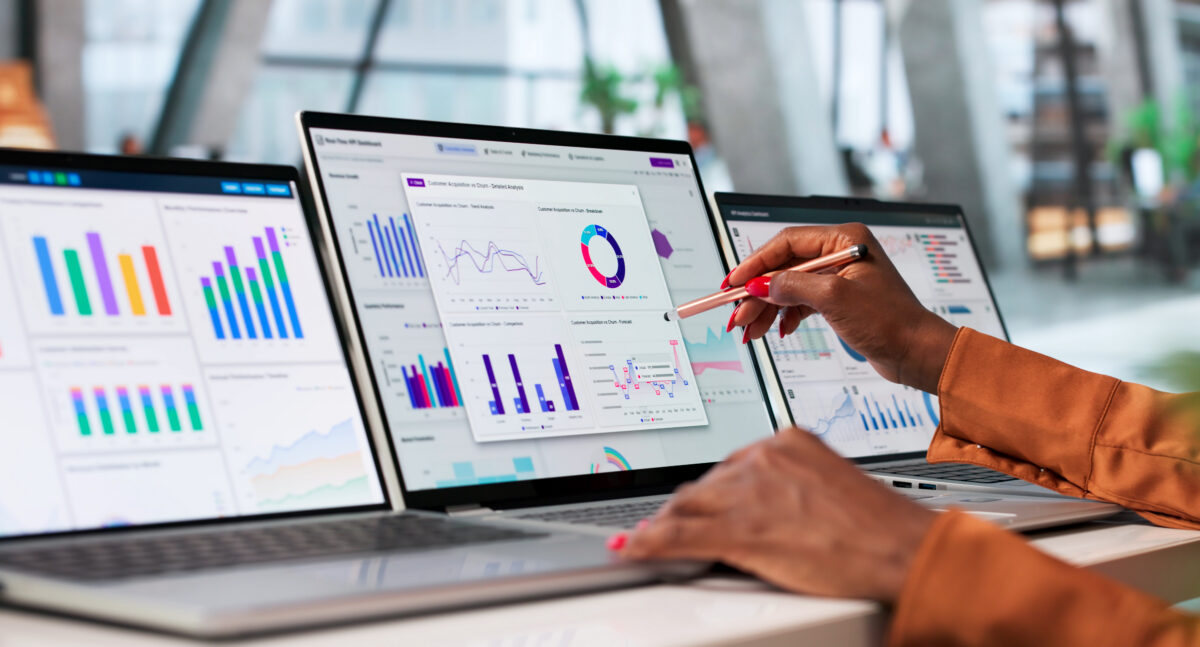 Young Financial Analyst Reviews Market Trends On Laptop